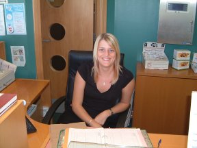 being a receptionist - Here's a receptionist at a local business. She's got a welcoming smile and a winning attitude.