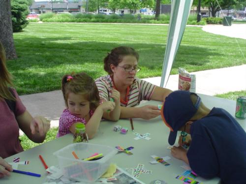wobble racers - Even moms and sisters got involved with making wobble racers at Pack 48's booth at the 2007 Scout Show.