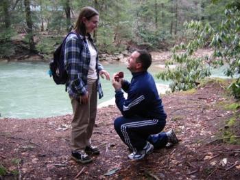 Propose - A man down on his knee when he propose his lover on a river travelling. Such a romantic moment