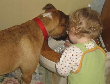 My daughter and her dog - playing in the potty