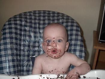 baby cake face - baby&#039;s first cake. and it&#039;s all over her face.