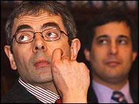 Rowan Atkinson - Mr Been little more serious here as Rowan Atkinson he listen a speech in a meeting.