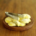 Tortellini - Picture of tortellini on a wooden board with tongs