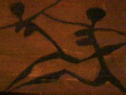 two women running... - Tribal painting of 2 women running on wood.. 