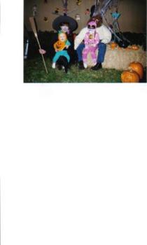 Halloween - This is a picture of me and 2 of my kids with the large wolf man in the back. In front of our home all decorated for Halloween.