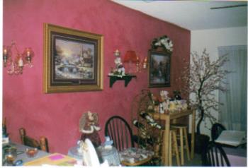 Decorated Dining room - The wall was sponged with a sponge roller using a couple of different colors of paint and going over the wall several times, it took about 4 days to complete.

The Little bar table and stools were picked up at a garage sale for $10 they were like brand new.

The picture closest to the camera I picked up at Sam&#039;s club for $49.99 not bad price. The one next was a gift at Christmas. The candle sconces were purchased years ago through a Home Interiors party that I went to, I think they were about $50 total for the glass globes (6) and 2 brass sconces.

All the knick knacks on the shelf and the little decorative table came from bargain stores and garage sales or were gifts. The bar table had a few of my beanies from my collection.

The tree in the corner was purchased years ago at a furniture store for about $70.00. Our local flea market sells the same stuff for half that price and they are brand new items.

The wine rack was from someone I knew and they were throwing it out, just my luck.

I love candles and think they add a lot to any room so I do use a lot of them through out my home.

Hope this helps and gives you some ideas.