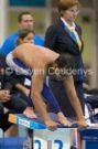 competitive swim dive - a swimmer poised on the diving board at the start of the swim competition