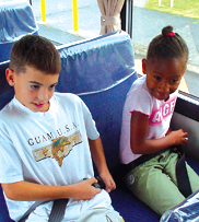 Children with Seatbelts on Bus - Photo of two children using seatbelts on what apears to be a school bus.