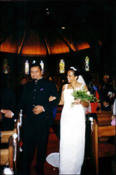 On Our Wedding Day - This was taken on our way out of the Church - the background is a little dark but the church where we had the wedding was absolutely beautiful and just the right size :)