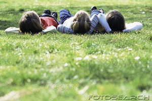 Kids - Kids lying on a field on a lovely summers day.