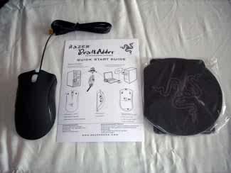 Razer DeathAdder Gaming Mouse - I was quite surprised when I saw the packaging for the mouse, because it was much smaller than I expected. The front of the box loudly broadcasts that the mouse uses a 3G Infra-red sensor and is capable of 1800 DPI. The back of the box really impressed me because it has the features of the mouse in ten different languages! The right side of the box displays a comparison of the DeathAdder against a standard 400-800 DPI optical mouse. It also shows that the Razer DeathAdder takes 55% less motion to move on the screen versus a standard mouse. On the left side, “RazerGuy” has a two paragraph message for the patrons of the DeathAdder.