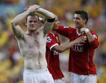 Celebrations after FA Cup semis win - Man Utd&#039;s Wayne Rooney salutes the fans as teammates Wes Brown and Christiano Ronaldo celebrate after their FA Cup triumph