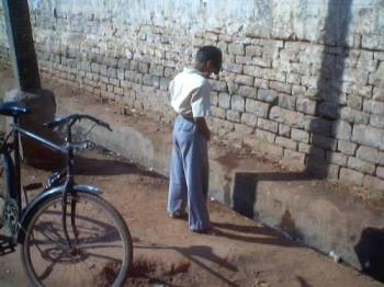 Urinating in Public places - A boy passing urinals at a public place.