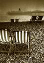 Brighton Beach Evening - Deck chairs on a deserted Brighton Beach in the evening.