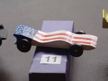 Pinewood derby car - This car was a favorite among many for it's design and the fact that the flag looks tp be waveing in the breeze. Pinewood derby car - This car was a favorite among many for it's design and the fact that the flag looks tp be waveing in the breeze.