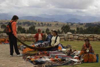 shopping - tourist shopping for blankets at rural market