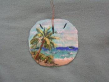 beach scene - This is a beach scene I painted on a sand dollar shell.