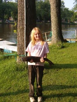 Caroline and her 6+ pound catfish - This is a pic of our daughter and the catfish she caught while camping Memorial weekend. 9yrs old and she fought this s*cker for a good 20min. in a boat to reel it in. Dad helped with the net once it got close enough. 