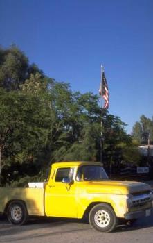 Slick pickup truck with American Flag - I would love for our son to end up with something like this antique yellow pickup truck.