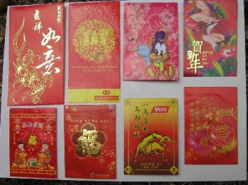 red packet or ang pau - These red packets are red envelopes with certain amount of money inside.