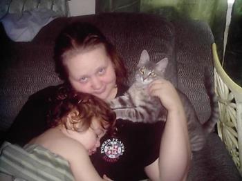 This is a picture of me and my son Angel with our  - This is a picture of me and my son Angel with our kitten Fuzzy.