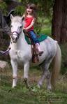 A birthday girl enjoying a pony ride - pony ride for a birthday girl A birthday girl enjoying a pony ride - pony ride for a birthday girl