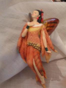 porcelain angel - This is another angel from my porcelain set. She is called "Pheasant&#039;s Flight". Her skirt is feathers and she has a feather in her dark hair.