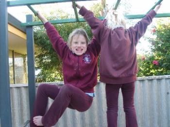 Girls playing - My granddaughters Amy and Chelsea on the bars.