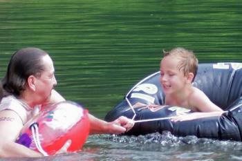 My husband and our son relaxing in the Buffalo Riv - This photo was taken on one of the last trips that we took to the Buffalo River...it is one of the historical rivers that the USA goverment named as a State Park... 