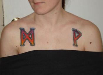 The edges of my chest piece - This is the beginning of my chest piece, which is a pair of Norse runes, "dagaz" and "wunjo." "Dagaz" translates roughly to "dawn," and "wunjo" translates roughly to "joy."