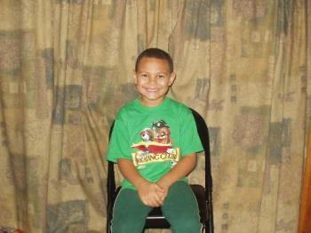 My oldest grandson - He's sitting in front of curtains that we made to cover the books on the bookshelves so it would make it look less cluttered in the living room. It also gives us a nice background for picture taking for the kids. My oldest grandson - He's sitting in front of curtains that we made to cover the books on the bookshelves so it would make it look less cluttered in the living room. It also gives us a nice background for picture taking for the kids.
