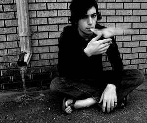 People - Black and white photo of a man smoking.