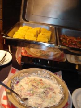 buffet - In this specific photo is several corns, chicken barbecue, and salad, which are all part of the buffet. buffet - In this specific photo is several corns, chicken barbecue, and salad, which are all part of the buffet.