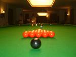 Snooker... - Snooker is a kind of table game in which u have to pocket the balls on the table into the six holes of the table.. U just have to use the white ball to pocket them all, all balls carry different points..
