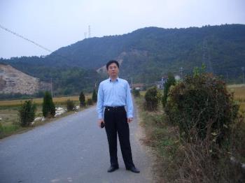 self-taken photo in the country close to the Mt - This is me standing on one side of the countryroad with the mountain as the background.