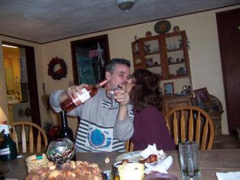 Toasting love and life with wine and a kiss! - A photo of my hubs and I toasting life and love with a glass of wine and a big kiss during Christmas 2006!