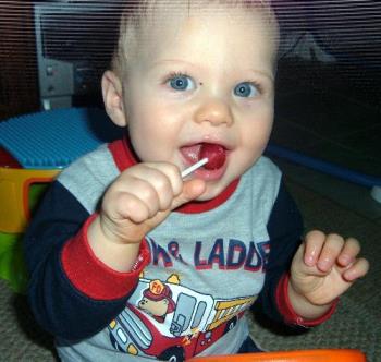 Grandson eating a sucker - Little boy enjoying his first sucker!