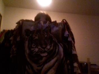 this is me and my favorite blanket - I sleep with 3 different blankets but this one is the softest blanket. I love tigers. I love making these no sew blankets.