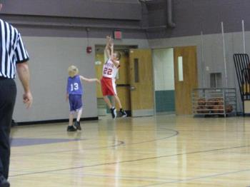 Basketball Game - This photo was taken with a Canon Powereshot S5 IS. It was taken indoors with available light. It is a nice shot but not a sharp and clear as one taken with a DSLR.