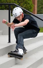 Stair Rollerblading  - Guy doing a trick on the stairs with rollerblades 