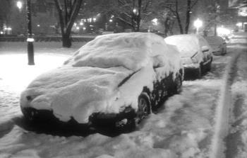 Winter in Montreal - A snow covered car in a snow covered street in Montreal