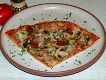 Pizza Napolitana - The right thickness of pizza, this one with italian sausage, green peppers, mushrooms, pizza sauce