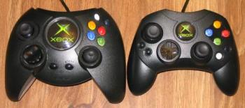 X-Box Controllers - These are the X-Box Controllers. The big one was the first while the smaller version came later one. The changes aside from size can also be distinguished from the button lay out compared to the first controller wherein the black and white buttons are fairly moved closer or reach and the initial four coloured buttons are now layed out in a cross-like way, symmetrical with the directional buttons on the other side