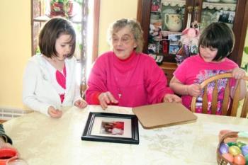 Children with their Aunt - In this photo you see an Aunt with her two nieces looking at a picture. All appear to be relaxed and Natural. They were not expecting to have their photo taken