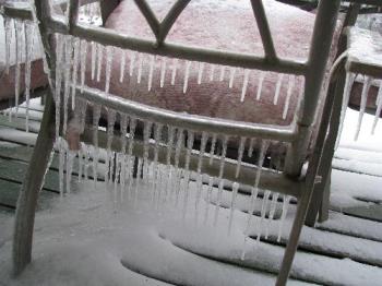 Icicles hanging from &#039;summer&#039; deck chairs - This photo was taken from our deck after a winter storm in Manitoba on April 24th. They are a common part of winter...but not usually present in &#039;Spring."