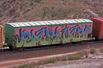 A Train With Graffiti - This is a container train with graffiti on one of its' container A Train With Graffiti - This is a container train with graffiti on one of its' container