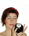 Magic 8 ball - This is a photo of a woman holding the Magic 8 ball and asking a question she wants answered. 