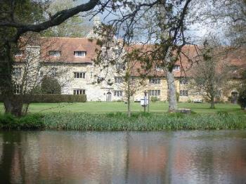Michelham Priory Across Moat - Michelham Priory from the other side of the moat, which area is accessible by low, wooden bridge, across the water. Michelham Priory Across Moat - Michelham Priory from the other side of the moat, which area is accessible by low, wooden bridge, across the water.