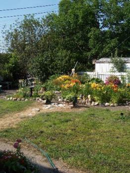 View of our west garden - Our garden is mix of annuals, perennials, herbs and vegetables. This image is the West garden.