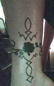 A picture of my ankle tattoo redone.  - This is a picture of the tattoo on my ankle that I just recently got redone. I love it! It is a clover with celtic designs that turn into a cross.